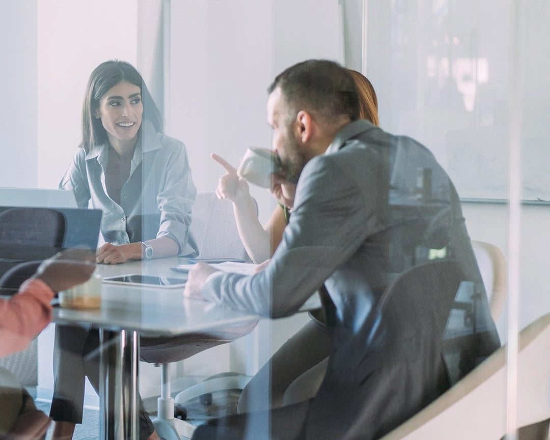 Group of people in a modern office setting during a meeting.